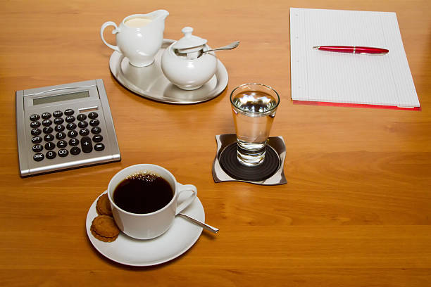 Comparison of water and coffee cups on a desk